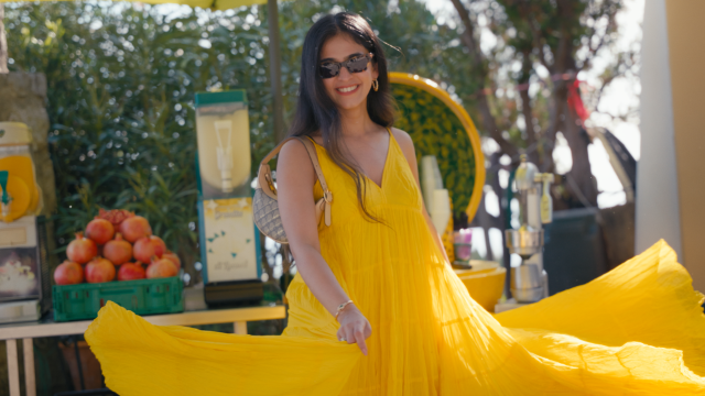 bride smiling and swirling in her yellow dress during pre wedding shoot in positano