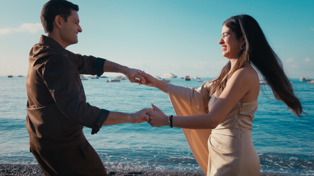 bride and groom dancing on the beach during sunrise in positano